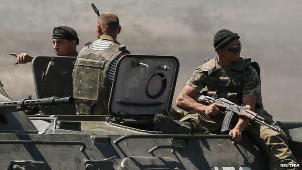 Ukrainian border guards ride armoured personnel carrier along the Ukraine-Russia border near the eastern village of Marynivka. Photo: 6 June 2014