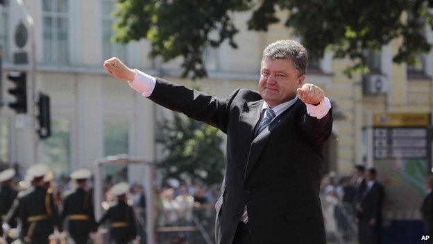 Ukrainian President Petro Poroshenko lifts his arms in greeting after the inauguration ceremony in Sophia Square in Kiev