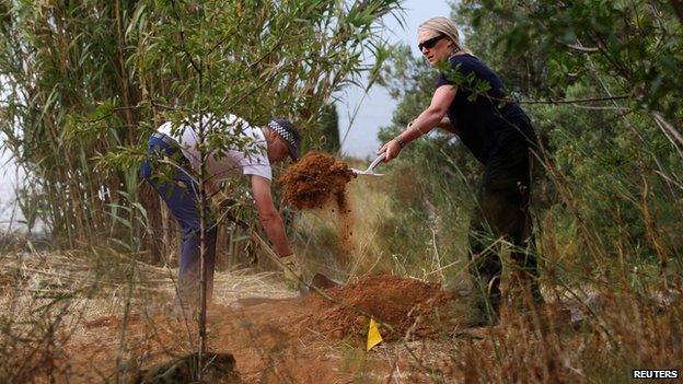 Officers clearing scrubland