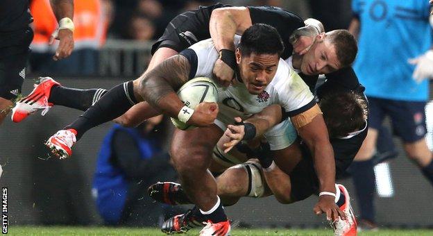 Cory Jane and Richie McCaw try to bring Manu Tuilagi to ground