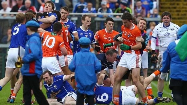 Young band members were forced to run for cover as both sets of players squared up to each other at the Athletic Grounds