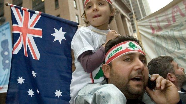 A demonstrator carries his daughter on his shoulders as they participate in a demonstration outside the US consulate to denounce the Israeli attacks on Lebanon and Gaza on 22 July, 2006 in Sydney, Australia