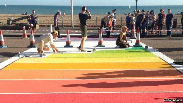 Artists working on the rainbow crossing