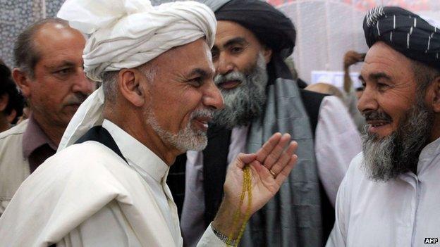 Afghan presidential candidate Ashraf Ghani Ahmadzai gestures as he arrives at an election campaign rally in Kandahar province on June 6, 2014.