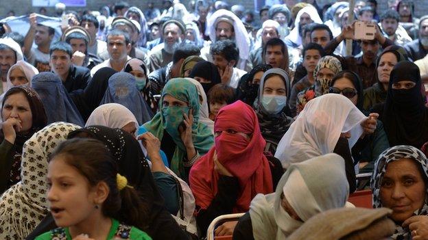 Supporters of Afghan presidential candidate Ashraf Ghani Ahmadzai listen to his speech at an election campaign rally on the outskirts of Kabul on June 4, 2014