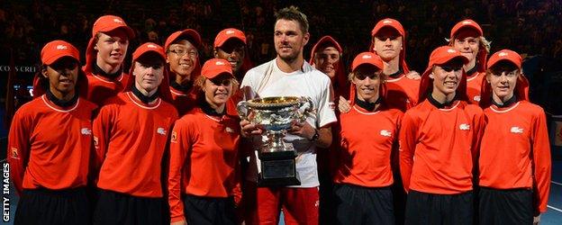 Stanislas Wawrinka celebrates his Australian Open win with the ball boys and girls