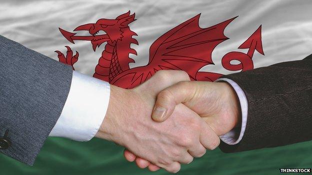 Shaking hands and Welsh flag