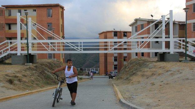 Boy walking with his bike in Ciudad Caribia