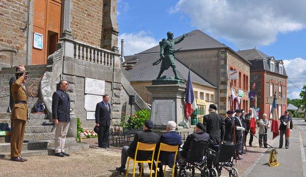 Veterans and their families sing the national anthem at Berjou