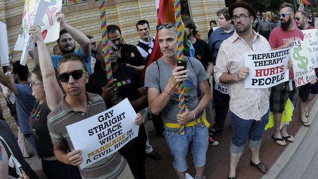 Gay rights protestors gather outside the hall of the Texas Republican State Convention on 5 June, 2014.