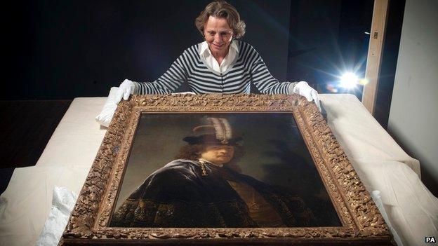 Tina Sitwell, Paintings conservation advisor, looking at the self-portrait of Rembrandt