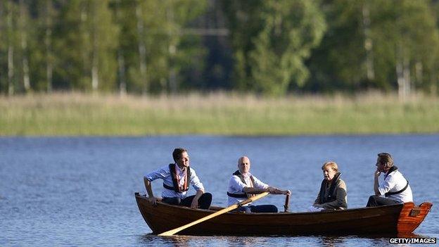 David Cameron, Angela Merkel, Fredrik Reinfeldt and Mark Rutte talk in a boat near the summer residence of the Swedish Prime Minister