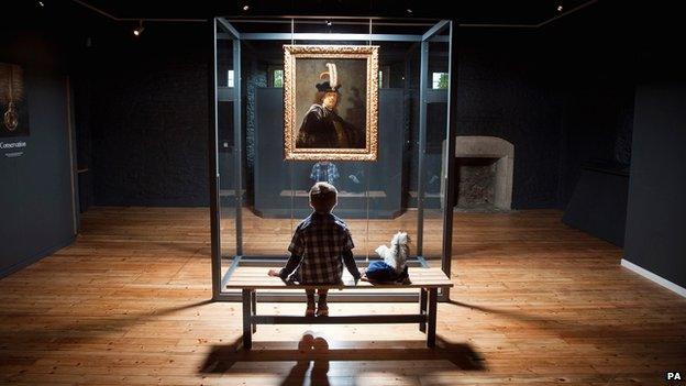 Young boy examining Rembrandt painting