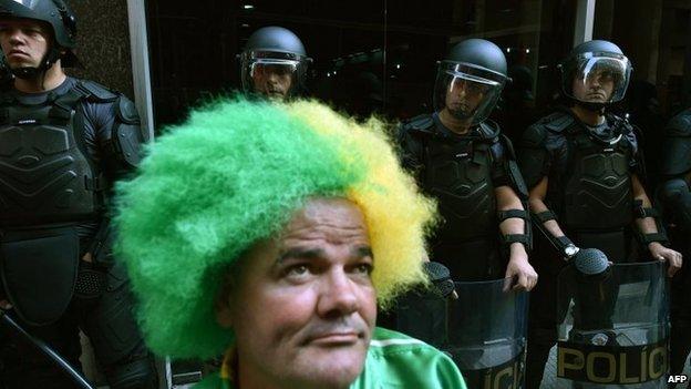 Riot police forces stand guard during a demonstration by striking subway workers on 9 June, 2014 in Sao Paulo,