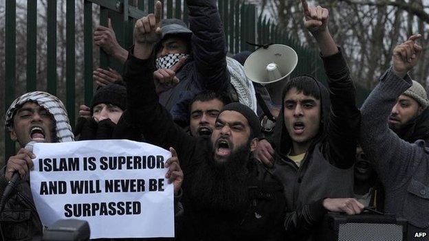 Protesters holding a banner that says "Islam is superior and will never be surpassed"