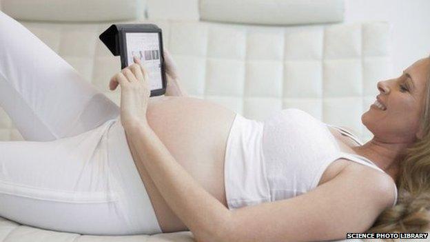 Pregnant woman using tablet