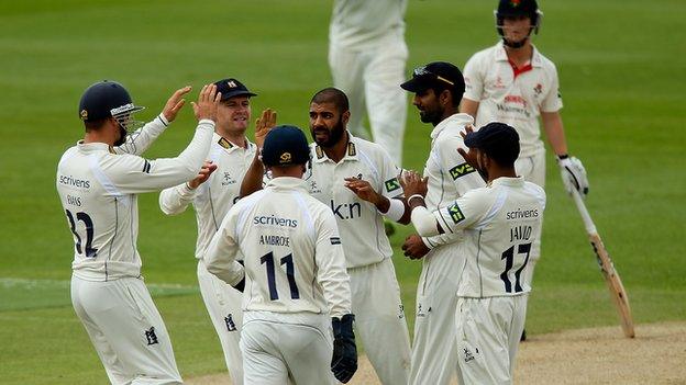 Warwickshire's players celebrate a Jeetan Patel wicket against Lancashire at Edgbaston