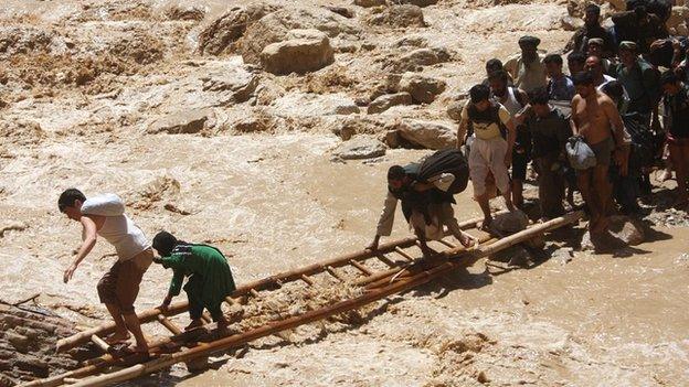 Heavy floods in Northern Afghanistan destroyed roads and houses and displaced thousands