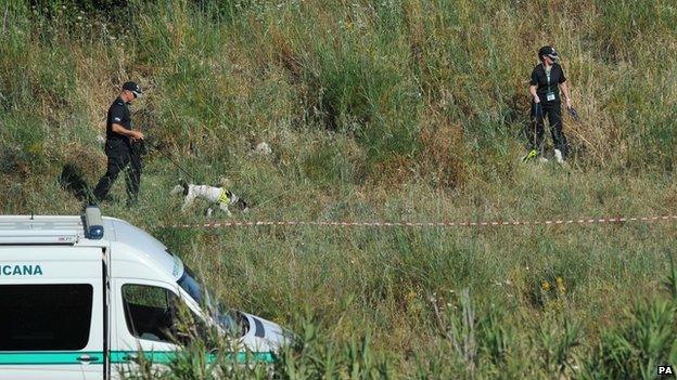 UK police searching the second site with a sniffer dog