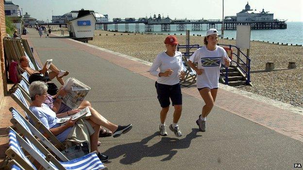 Arantxa Sanchez-Vicario jogging past people in deckchairs on Eastbourne seafront in 2001