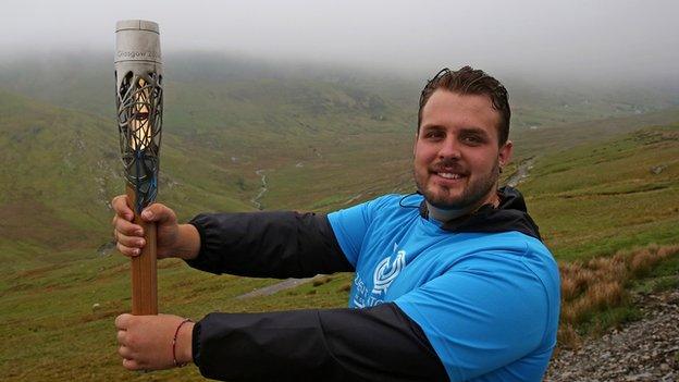 Aled Sion Davies with the Queen's Baton on Snowdon