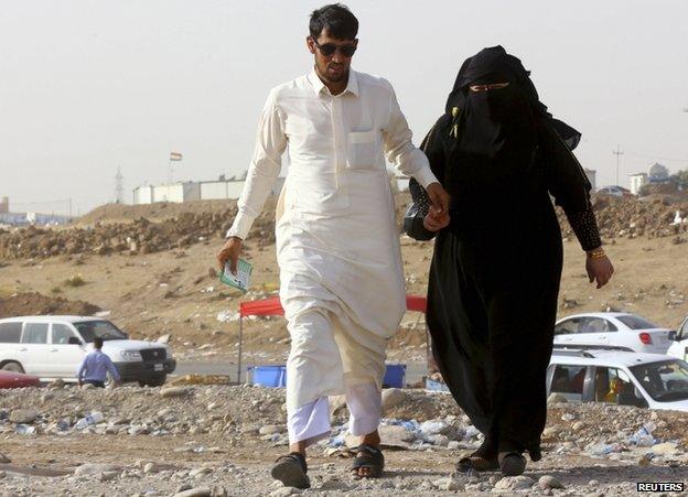 A couple who fled Mosul wait at a checkpoint in Irbil province, 11 June