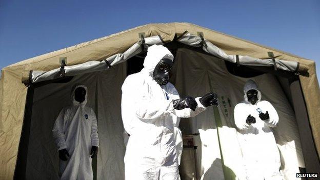 Members of the Brazilian army prepare for a simulated chemical and radiological attack exercise at the Mane Garrincha National Stadium in Brasilia on 9 June, 2014.