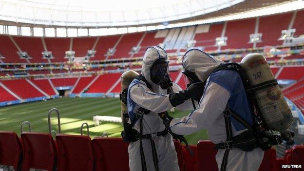 Members of the Brazilian Army take part in a simulated chemical and radiological attack exercise at the Mane Garrincha National Stadium in Brasilia on 9 June, 2014.