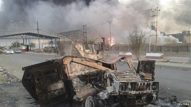 Burned-out military hardware after clashes in Mosul. 10 June 2014