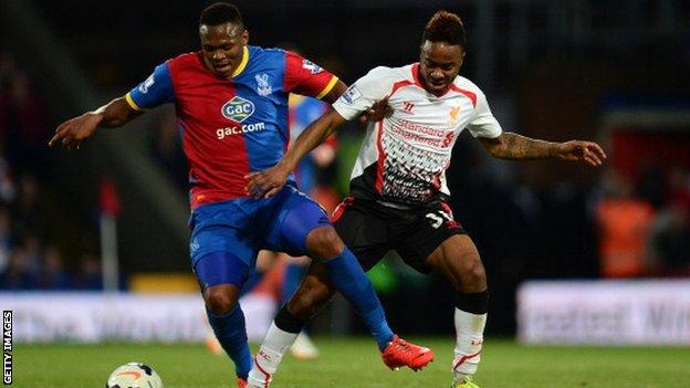 Kagisho Dikgacoi in action for Crystal Palace battling for the ball with Liverpool's Raheem Sterling.