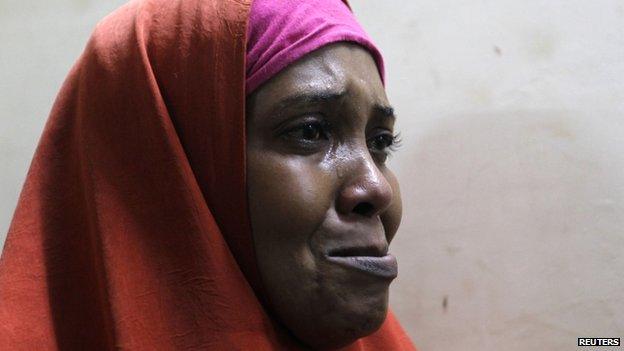 A suspected Somali illegal migrant arrested in a police swoop cries as she prepares to be processed for deportation at a holding station in Kenya's capital, Nairobi, 9 April 2014