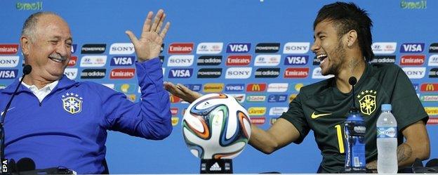 Brazil coach Luis Felipe Scolari and striker Neymar share a joke at a media conference before the team's opening game with Croatia