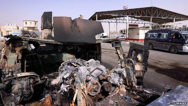 The remains of an Iraqi military vehicle sit outside of Mosul.