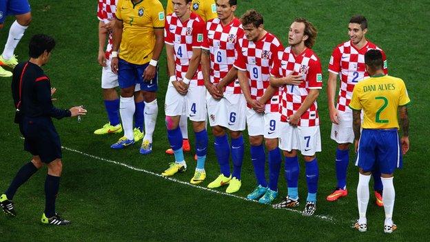 Referee Yuichi Nishimura uses vanishing spray during Brazil's win over Croatia