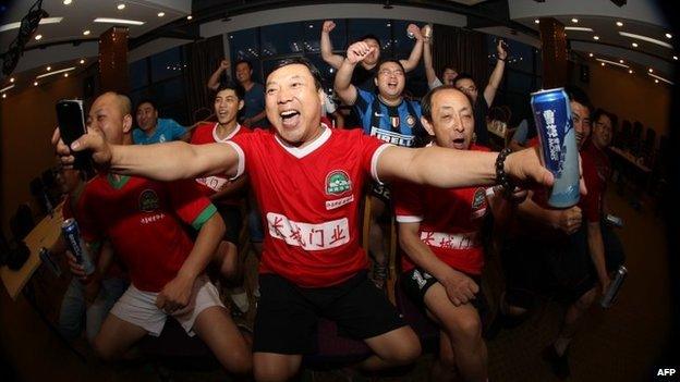 Chinese football fans react as they watch the opening football match between Brazil and Croatia of the 2014 World Cup, in Xuchang, north China"s Henan province on June 13