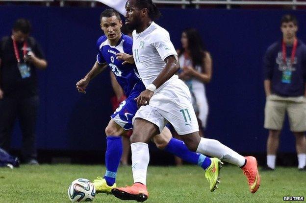 Ivory Coast player Didier Drogba (11) controls the ball as Bosnia player Sejad Salihovic (23) defends during a soccer friendly