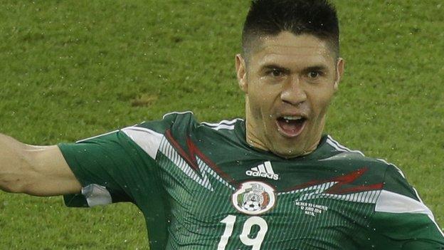 Mexico striker Oribe Peralta celebrates his goal against Cameroon