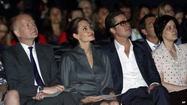 (l-r) British Foreign Secretary William Hague, US actress Angelina Jolie and US actor Brad Pitt at the final day of the "End Sexual Violence in Conflict" summit in London, on 13 June 2014