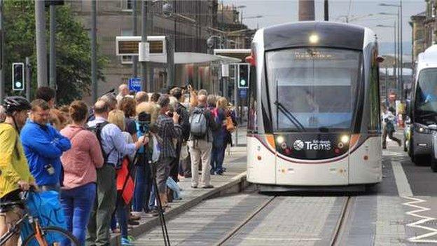 The baton has just reached Shadwick Place via one of Edinburgh's new trams after being carried by Scottish Hockey player Allan Dick.