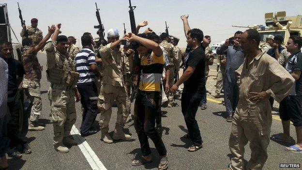 Members of Iraqi security forces and tribal fighters take part in an intensive security deployment on the outskirts of Diyala province June 13, 2014.