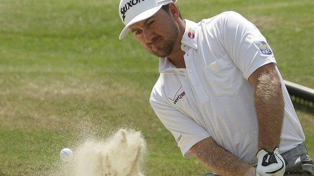 Graeme McDowell plays out of a bunker during his second round at the US Open