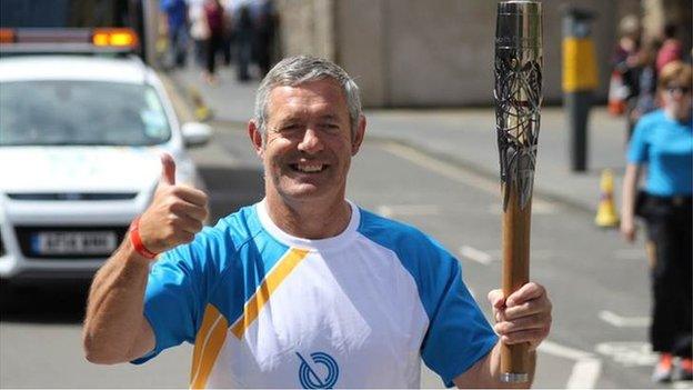 Former Scottish rugby captain Gavin Hastings carried the baton on the Royal Mile