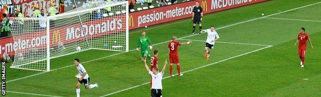 Germany's Mario Gomez (left) scores against Portugal at Euro 2012