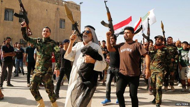 Volunteers who have joined Iraqi army parade in Baghdad on 14 June 2014