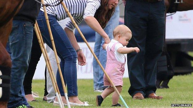 The Duchess of Cambridge holding Prince George's hand as he walks