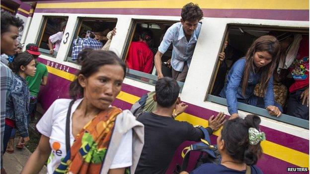 Cambodian workers get off a train as they prepare to migrate back to Cambodia at Aranyaprathet train station in Sa Kaew, Thailand, on 15 June.