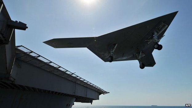 Unmanned aircraft leaves flight deck of aircraft carrier USS George HW Bush which has been ordered to the Gulf. May 2013