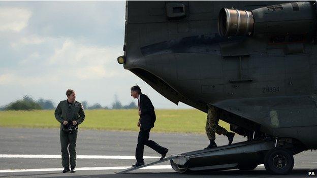 Defence Secretary Philip Hammond stepping out of a Chinook