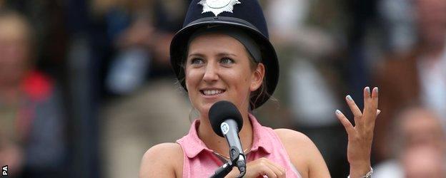 Victoria Azarenka wearing a police officer's hat while umpiring during the Rally for Bally at Queen's