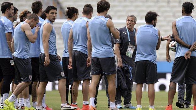 Uruguay coach Oscar Tabarez speaks to his players during training